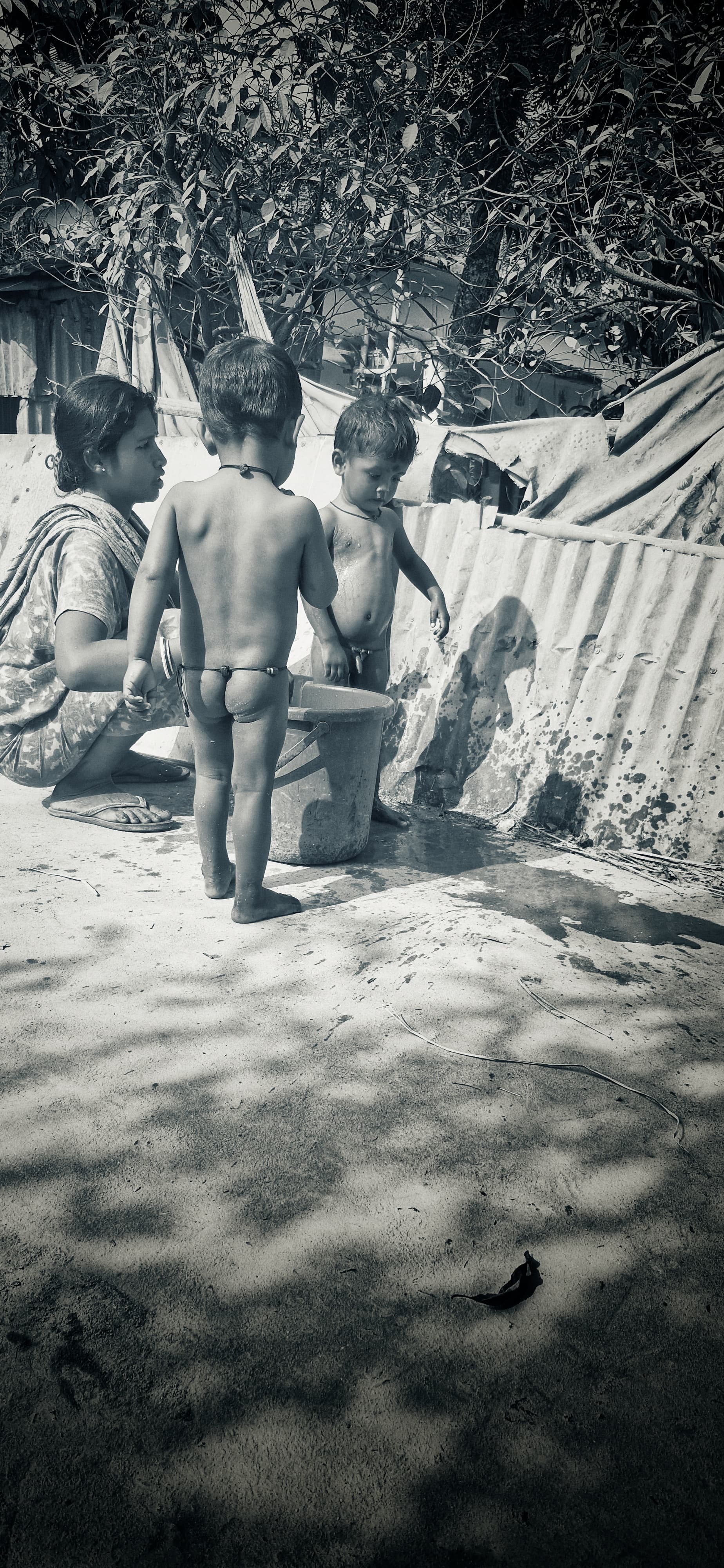 Mother bathing her children.